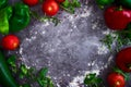 Kitchen table with space to write with flour and vegetables such as tomatoes, peppers, arugula, cucumber and spices. Food