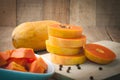 Kitchen table with stack layer slice fresh papaya, papaya seed o Royalty Free Stock Photo