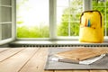 Kitchen table top with empty space for products or decoration, yellow schoolbag, blurred spring outside the window background. Royalty Free Stock Photo