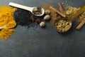 Kitchen table and various of spices on it.Wooden spoons full of spices.Cinnamon, turmeric, anise,sesamum, nutmeg, powder spices.Em Royalty Free Stock Photo