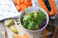 Kitchen table with vegetable salad on white plate and sliced of Royalty Free Stock Photo