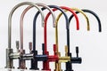 Kitchen taps of different colors Royalty Free Stock Photo