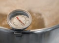 Kitchen thermometer measures the temperature of boiling wort beer homebrew Royalty Free Stock Photo