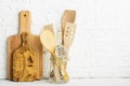 Kitchen tools, olive cutting board on a kitchen shelf against a white brick wall. selective focus