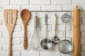 Kitchen tools, utensils, and kitchenware on white brick wall Royalty Free Stock Photo