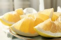 Kitchen towel and plate with pomelo slices, close up