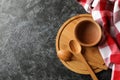 Kitchen towel and wooden dishes on black smokey background