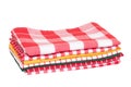 Kitchen towels isolated. Close-up of a stack of red white checkered and striped tableclothes or napkins isolated on a white Royalty Free Stock Photo