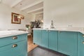 a kitchen with turquoise cabinets and a sink