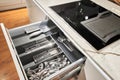 Kitchen utensil cutlery drawer organizer tray with simple set of tools, minimalist order. Open drawer with different Royalty Free Stock Photo