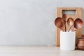 Kitchen utensils background. Wooden spoons and cutting board on light background with copy space Royalty Free Stock Photo