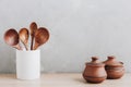 Kitchen utensils background. Wooden spoons in a white jug on light background with copy space Royalty Free Stock Photo