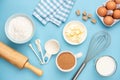 Kitchen utensils and baking ingredients on blue background