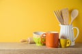 Kitchen utensils and dishware on wooden shelf. Autumn kitchen interior background Royalty Free Stock Photo