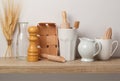 Kitchen utensils and dishware on wooden shelf. Royalty Free Stock Photo