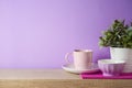 Kitchen utensils and dishware on wooden shelf. Kitchen interior purple background Royalty Free Stock Photo