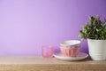 Kitchen utensils and dishware on wooden shelf. Kitchen interior purple background Royalty Free Stock Photo