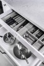 Kitchen utensils in drawer. Forks, spoons and knives.