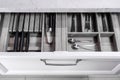 Kitchen utensils in drawer. Forks, spoons and knives.