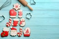 Kitchen utensils near Christmas tree shape made of delicious gingerbread cookies on light blue wooden table, flat lay. Space for Royalty Free Stock Photo