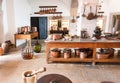 Kitchen utensils in retro style. Interior of an big old house with vintage table, traditional cooper pots for cooking