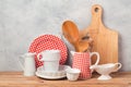 Kitchen utensils and tableware on wooden table over rustic grey background Royalty Free Stock Photo