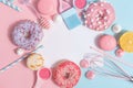 Kitchen utensils and tools, pastries and sweets on a pink and blue background. Top view. Copy space