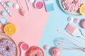 Kitchen utensils and tools, pastries and sweets on a pink and blue background. Top view. Copy space Royalty Free Stock Photo