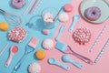Kitchen utensils and tools, pastries and sweets on a pink and blue background. Top view. Copy space Royalty Free Stock Photo