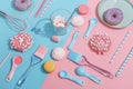 Kitchen utensils and tools, pastries and sweets on a pink and blue background. Top view. Copy space Royalty Free Stock Photo
