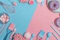 Kitchen utensils and tools, pastries and sweets on a pink and blue background. Top view. Copy space Royalty Free Stock Photo