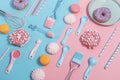 Kitchen utensils and tools, pastries and sweets on a pink and blue background. Top view. Copy space Royalty Free Stock Photo