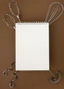 Kitchen utensils under blank white spiral notebook Royalty Free Stock Photo
