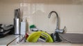 The kitchen utensils in the wash basin need to be washed. A pile of dirty dishes in the kitchen sink. Kitchen utensils need Royalty Free Stock Photo