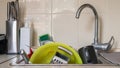 The kitchen utensils in the wash basin need to be washed. A pile of dirty dishes in the kitchen sink. Kitchen utensils need Royalty Free Stock Photo