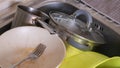 The kitchen utensils in the wash basin need to be washed. A pile of dirty dishes in the kitchen sink. Kitchen utensils need Royalty Free Stock Photo