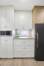 Kitchen with white cabinets and a black refrigerator Royalty Free Stock Photo