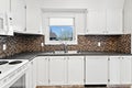 Kitchen with white cabinets and a sink Royalty Free Stock Photo