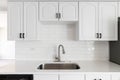 A white kitchen with a subway tile backsplash. Royalty Free Stock Photo