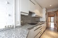 Kitchen with white cabinets, white brick and granite counterto Royalty Free Stock Photo