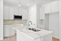 Kitchen with a white countertop and a white sink Royalty Free Stock Photo