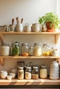 A kitchen white wall with shelves topped with lots of bottles, bowls and jars with spices and products