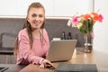 In the kitchen, woman with box-braids juggles work, fun, study