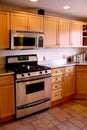 Kitchen wood cabinets stainless stove Royalty Free Stock Photo