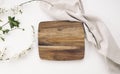 Kitchen wooden cutting board top view, serving dish empty space design, tableware on white. Food advertisement Royalty Free Stock Photo