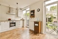 a kitchen with a wooden floor and a glass door Royalty Free Stock Photo