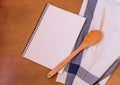 Kitchen wooden spoon with empty notebook Royalty Free Stock Photo