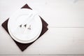 Kitchen. Wooden table with empty plate, tablecloth for dinner. Royalty Free Stock Photo