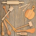 Kitchen wooden utensils spoon, plate, fork, pestle on a table