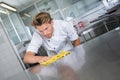 Kitchen worker wiping station Royalty Free Stock Photo